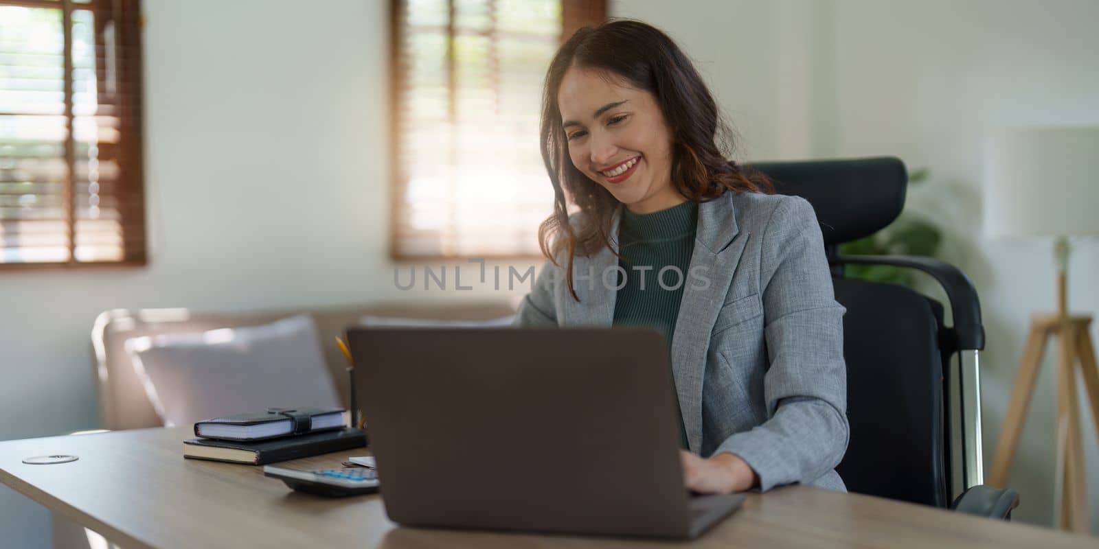 Asian Business woman working at home office and analyze financial report document. Accounting and Finance concept. by itchaznong