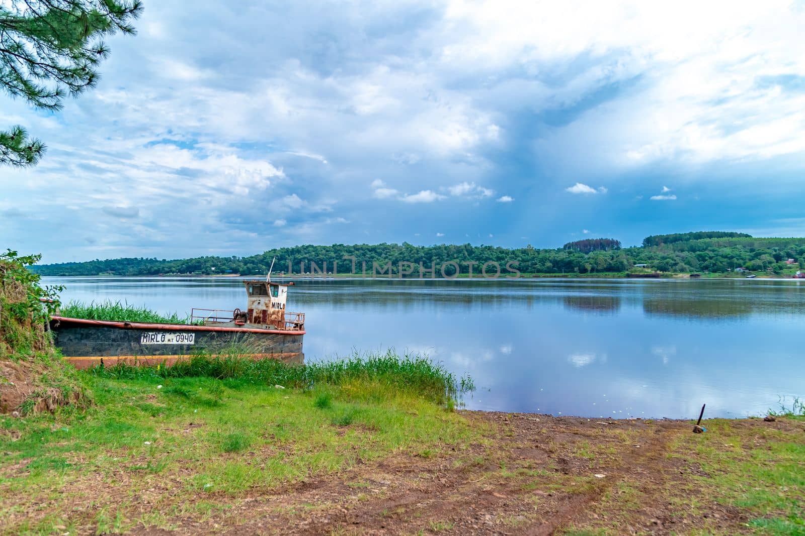 rusty cargo ship by the river. 