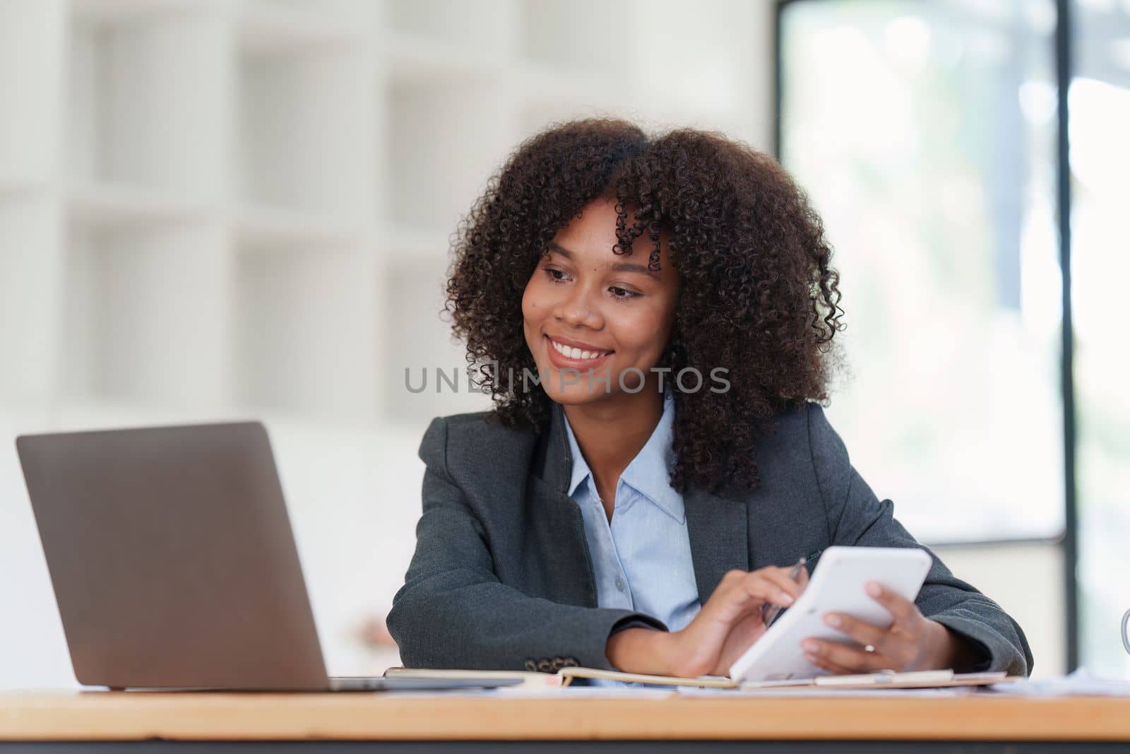 Financial advisor, corporate accountant and african woman in office. analyzing benefits, enjoying financial success, job high result by itchaznong