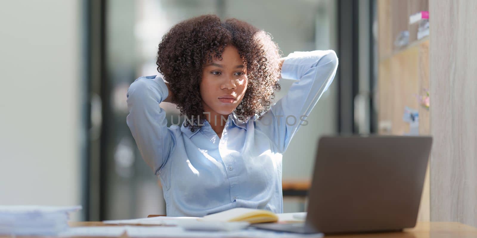 Portrait thoughtful confused young african american businesswoman looking at laptop. Stress while reading news, report or email. Online problem, finance mistake, troubleshooting by itchaznong