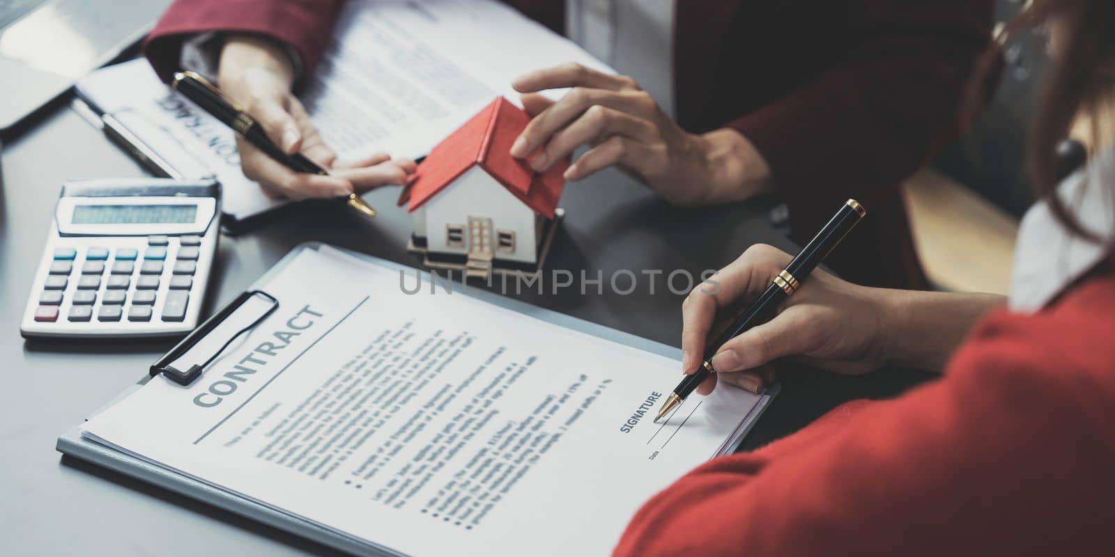 Real estate agent offer hand for customer sign agreement contract signature for buy or sell house. Real estate concept contact agreement concept by wichayada