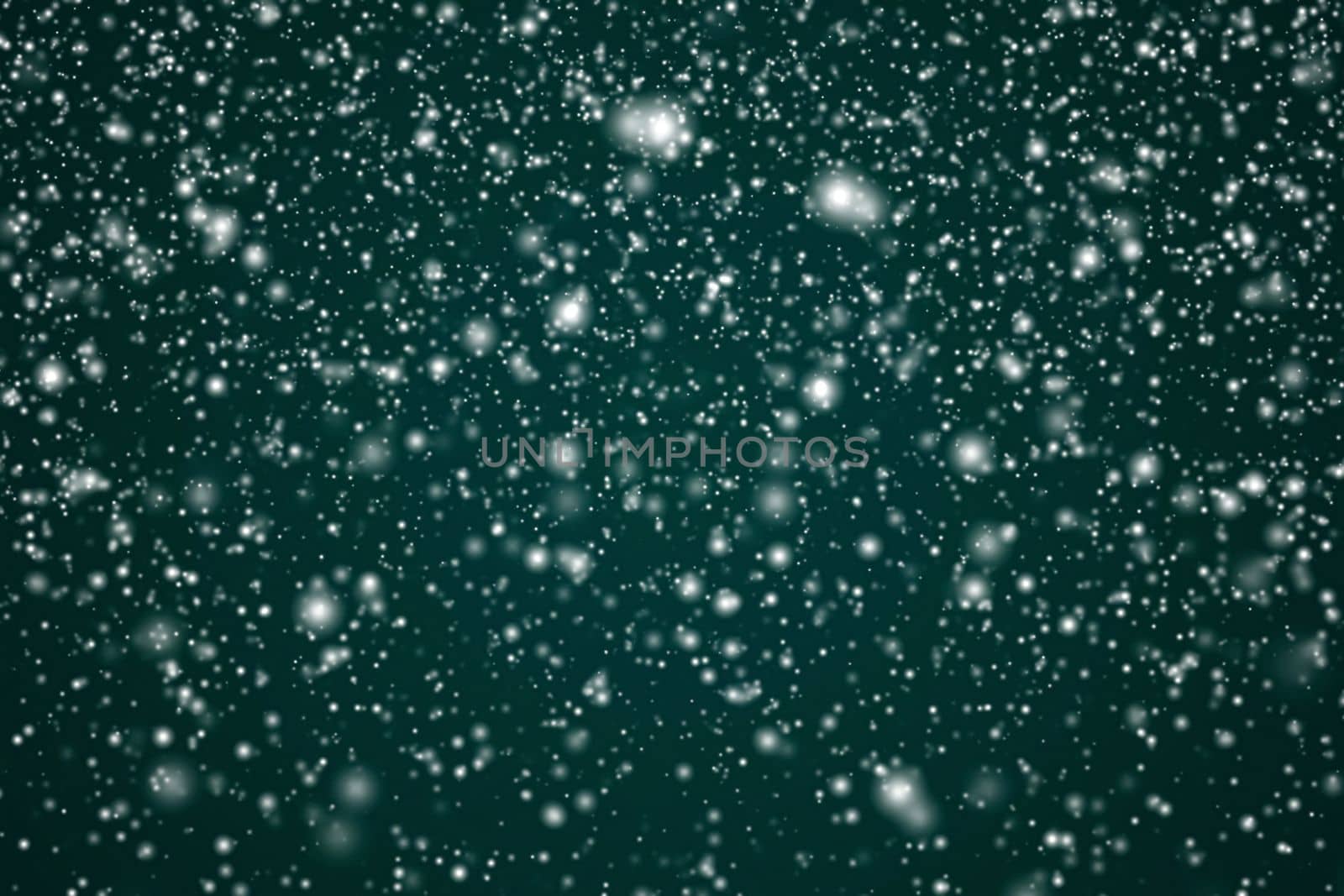 Winter holidays and wintertime background, white snow falling on festive green backdrop, snowflakes bokeh and snowfall particles as abstract snowing scene for Christmas and snowy holiday design by Anneleven