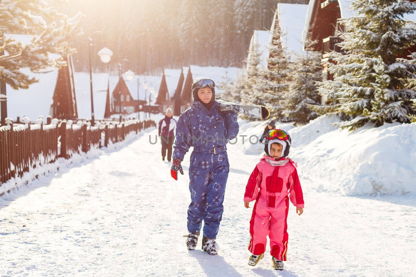 Portrait of smiling woman with cute little girl in wintertime. by Andelov13