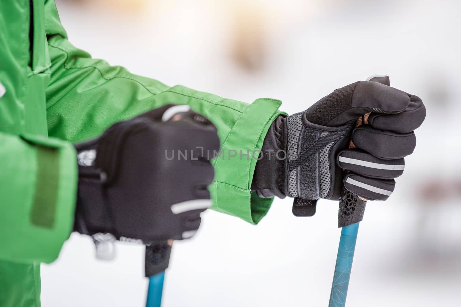 Nordic walking in winter. Sports activities in the winter on the snow. A man is engaged in Nordic walking with special sticks in the winter nature outdoors. Place for copy space