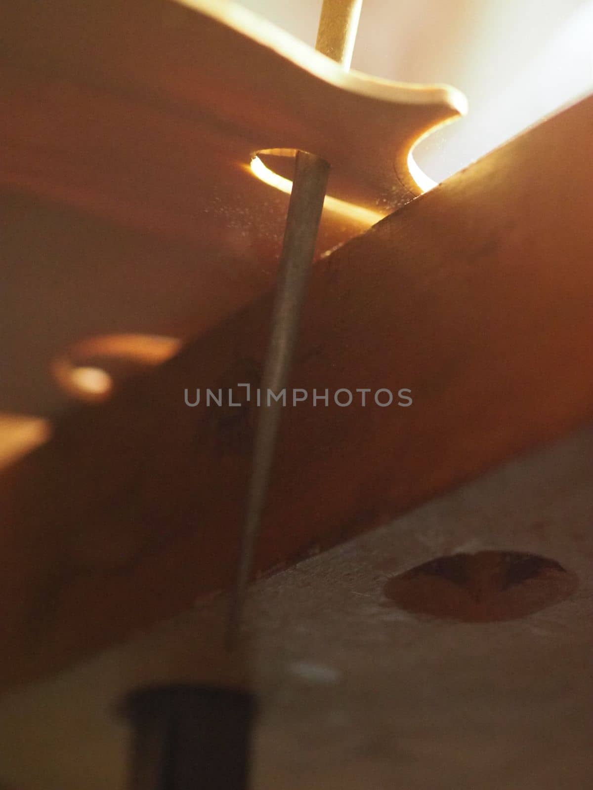 violinmaker cutting and sawing golden period cremonese violin model fholes with a blade with precision