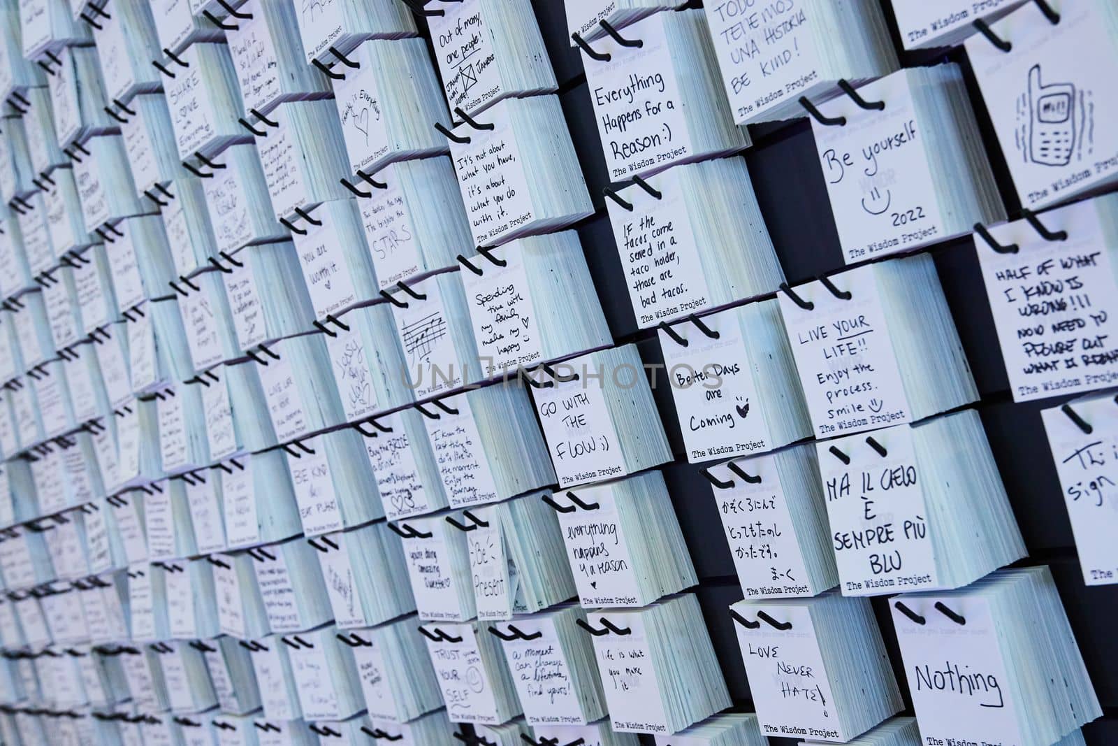Image of Wall covered in handwritten notes for facts about life from random people