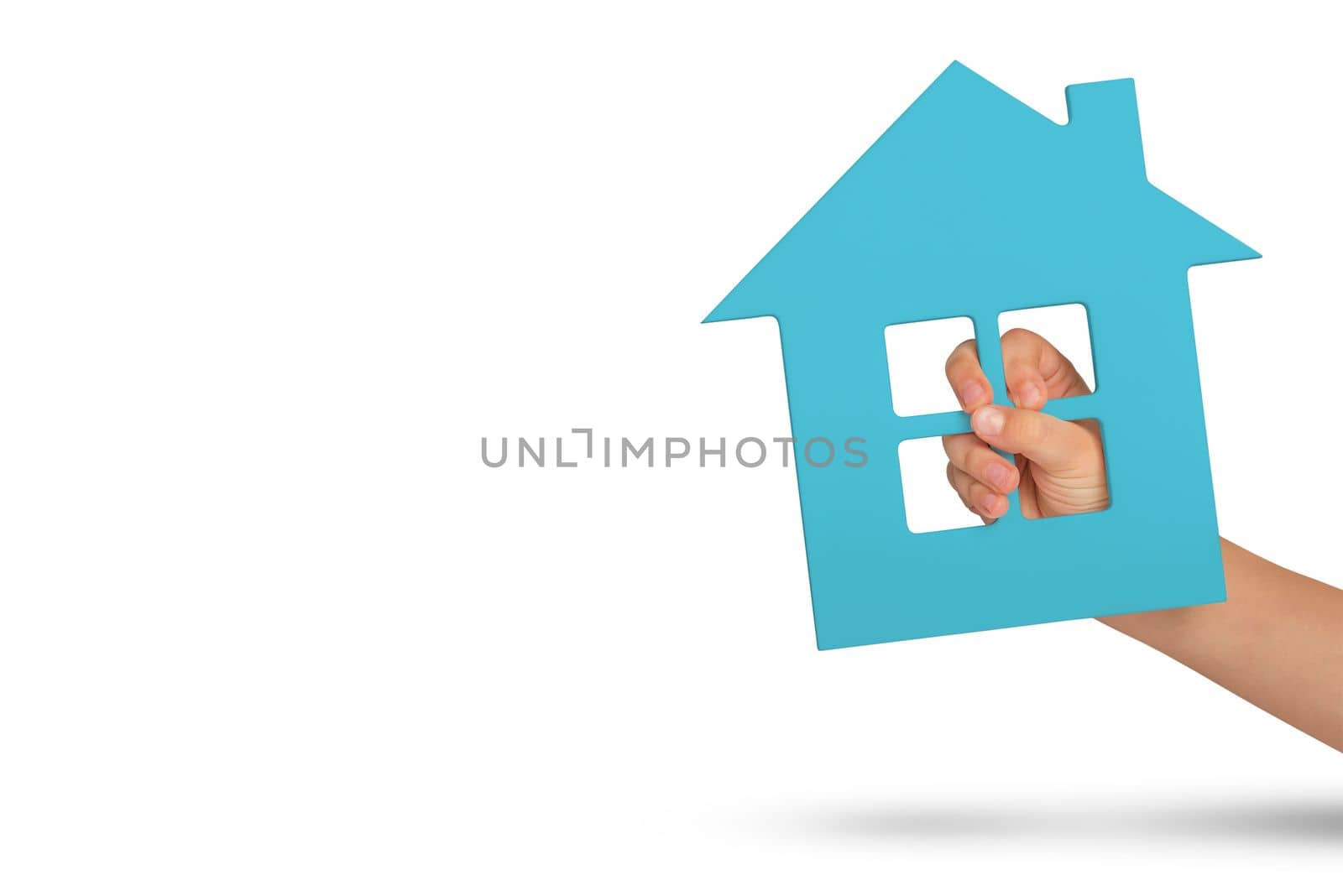 House in hand, isolation. Green model of a house in the hands of a child isolated on a white background. Homeless housing, family home, home insurance, international family day.