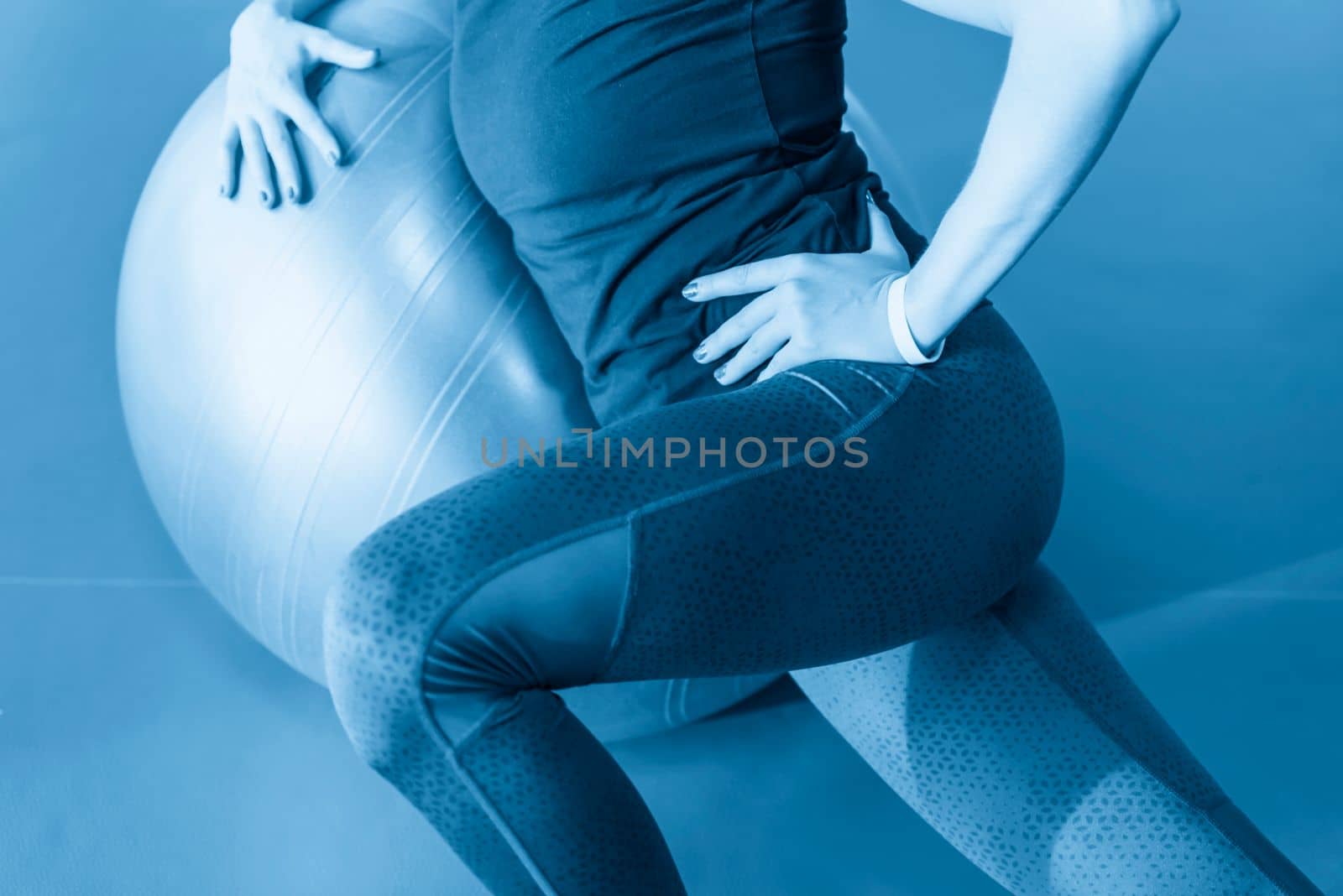 Woman at the gym with a pilates ball