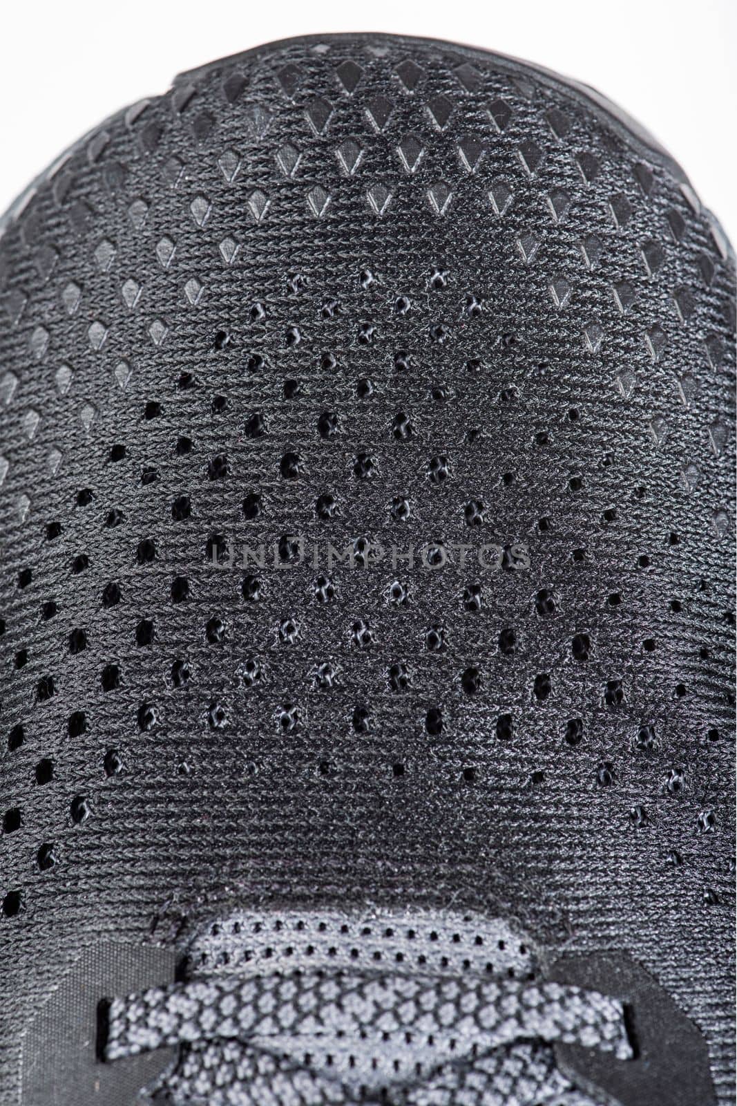 Mesh fabric of sports shoes in gray color. Shoes made of mesh fabric with a textile texture, for an active lifestyle, running and sports. Modern running shoes close-up. by SERSOL