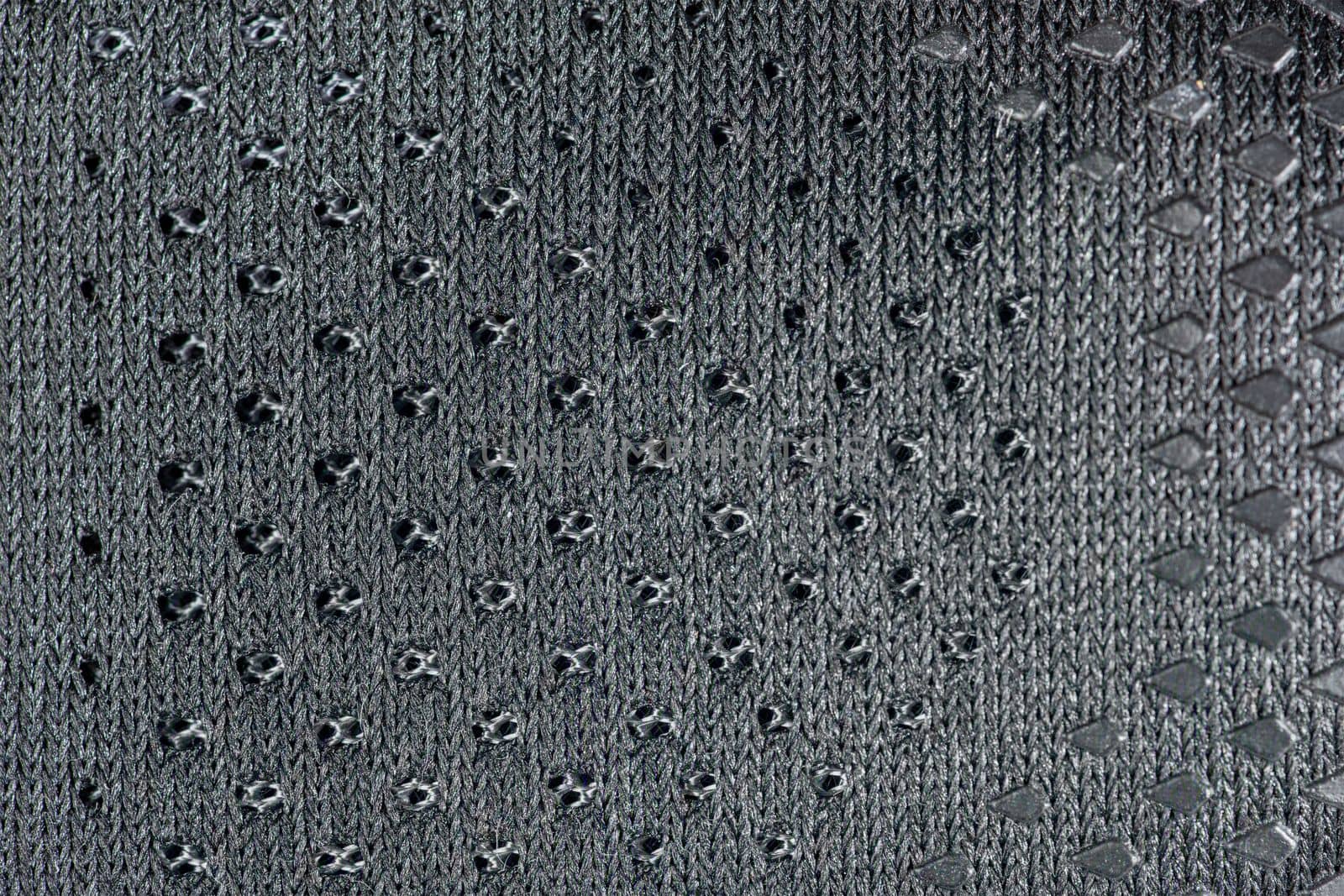 Mesh fabric of sports shoes in gray color. Shoes made of mesh fabric with a textile texture, for an active lifestyle, running and sports. Modern running shoes close-up