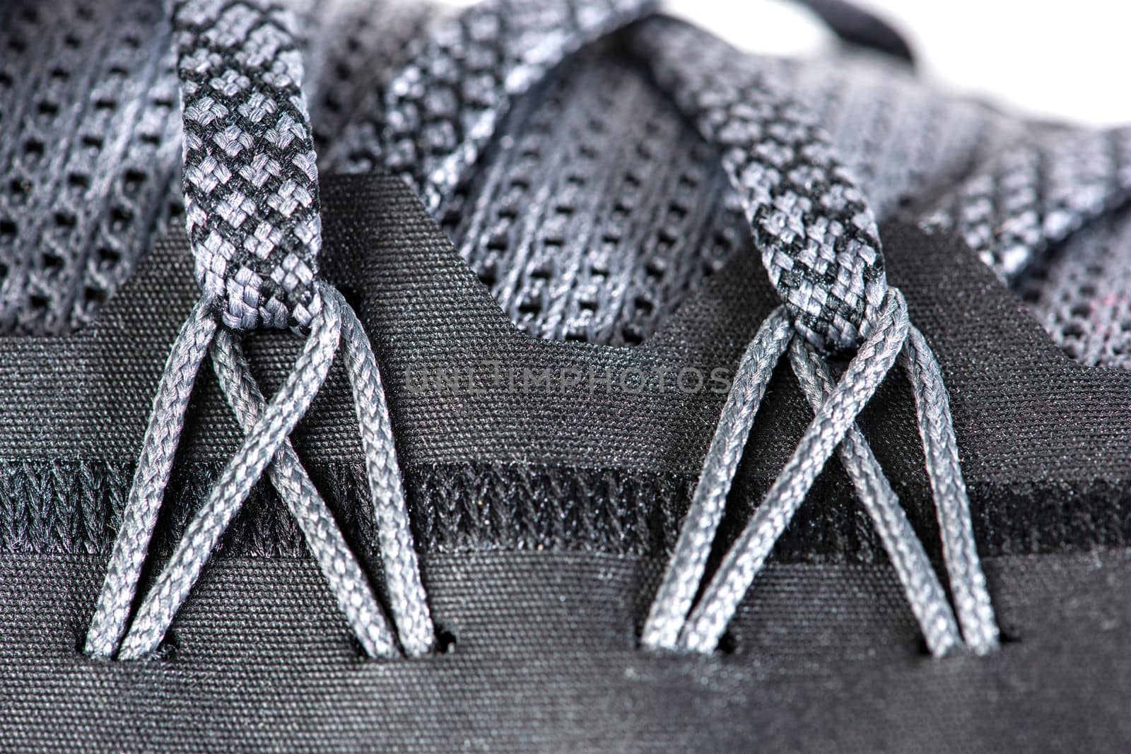 Sneakers close-up. Shoelaces of new sports shoes in gray, lacing sneakers close-up, top view. Mesh elastic laces for fitness. Sport and active lifestyle concept