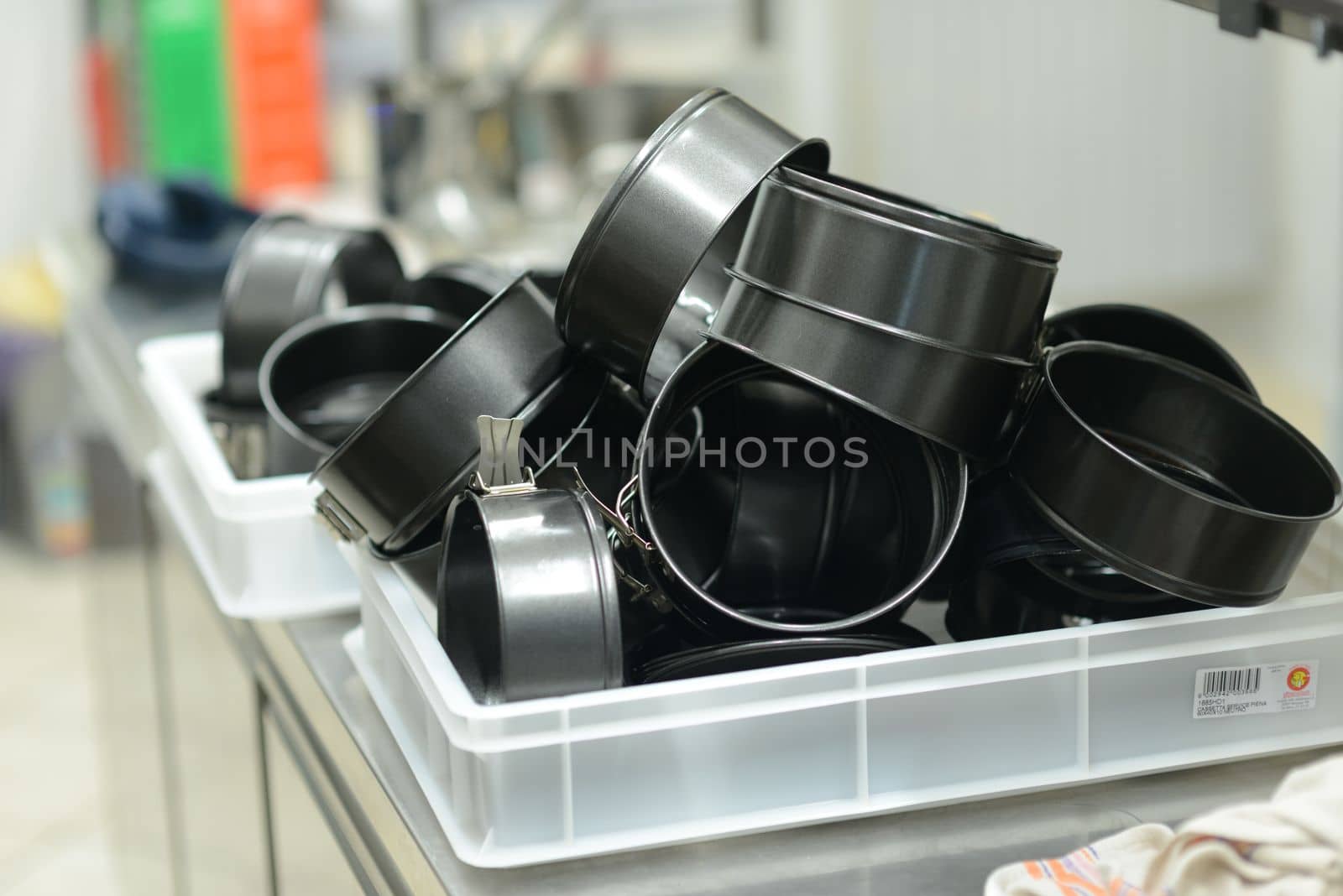 bunch of washed cake pans in professional kitchen by verbano