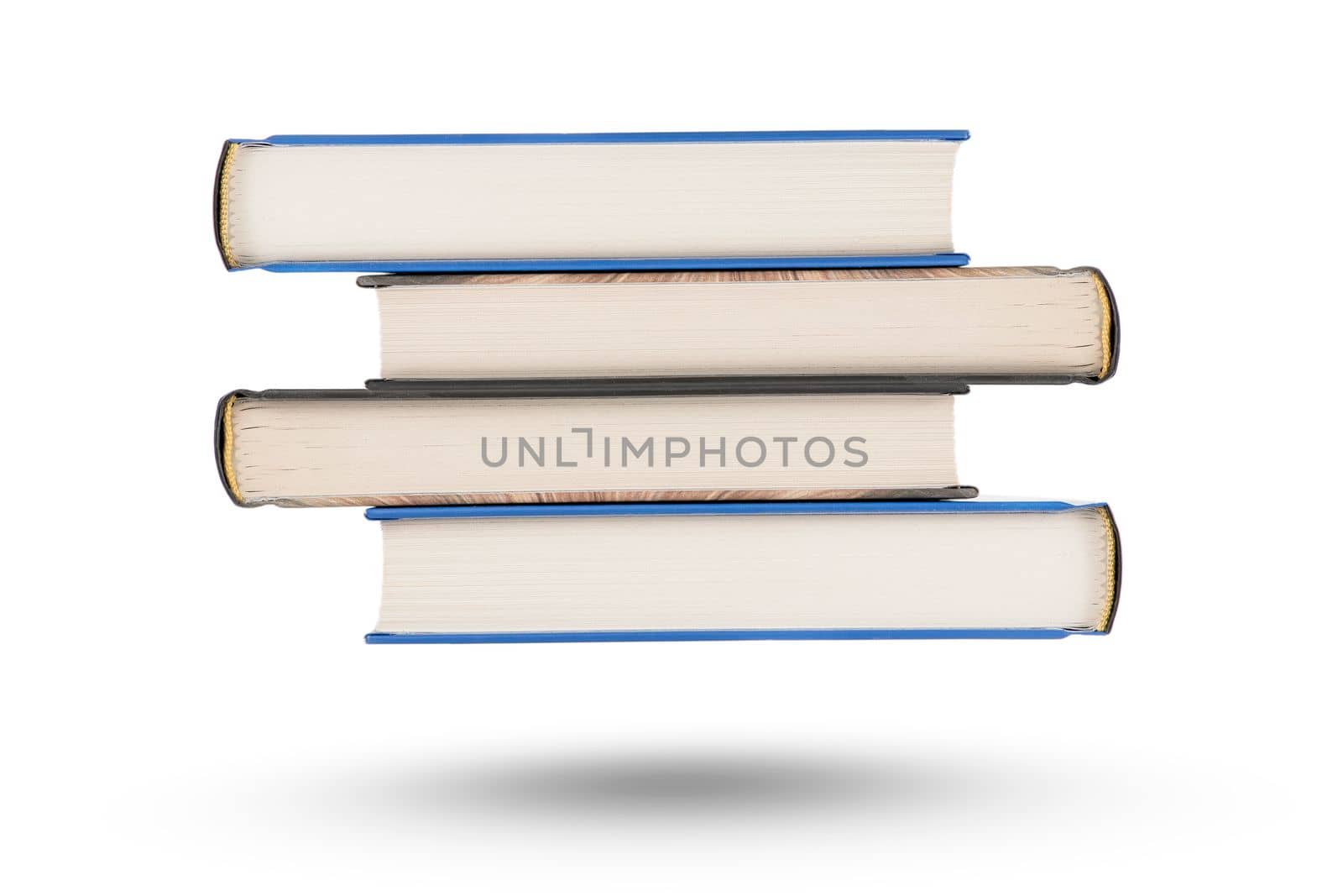 stack of books, isolate on white background. A stack of books of varying thickness falls, casting a shadow. Books are isolated on a white background, hanging in the air