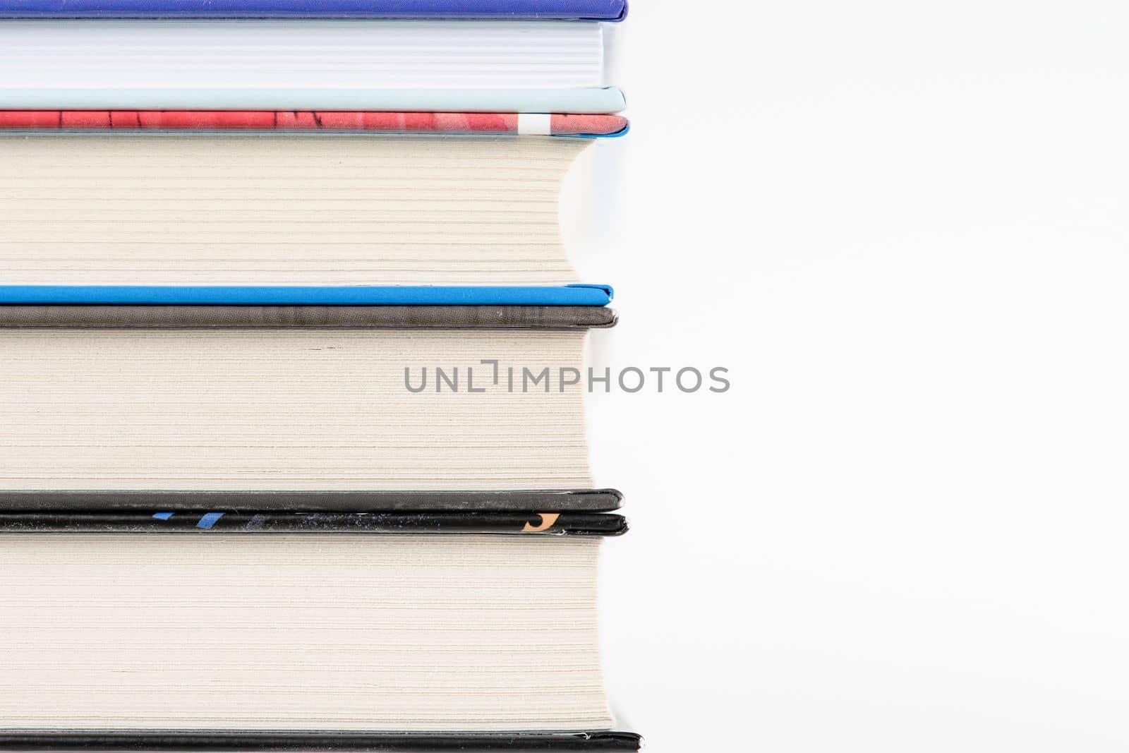 stack of books, isolate on white background. Stack of books of different thickness with place for text or copy space