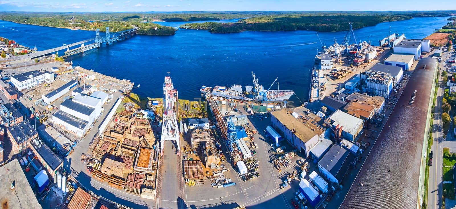 Panorama aerial over shipyard making military ships on river of Maine by njproductions