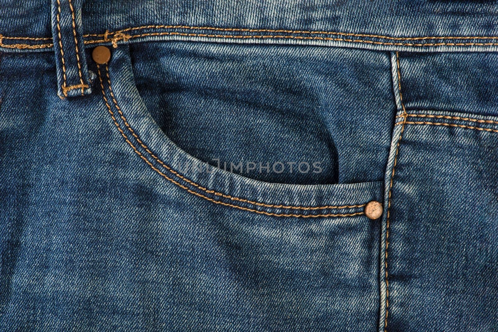 Pocket of old jeans. Empty front pocket of old blue jeans close-up