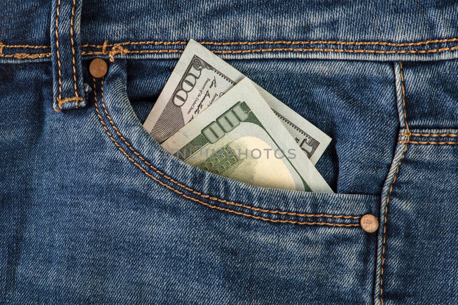 Stack of 100 dollar bills in jeans pocket. Money in the front pocket of jeans. The concept of investment, cash, wealth and profit.