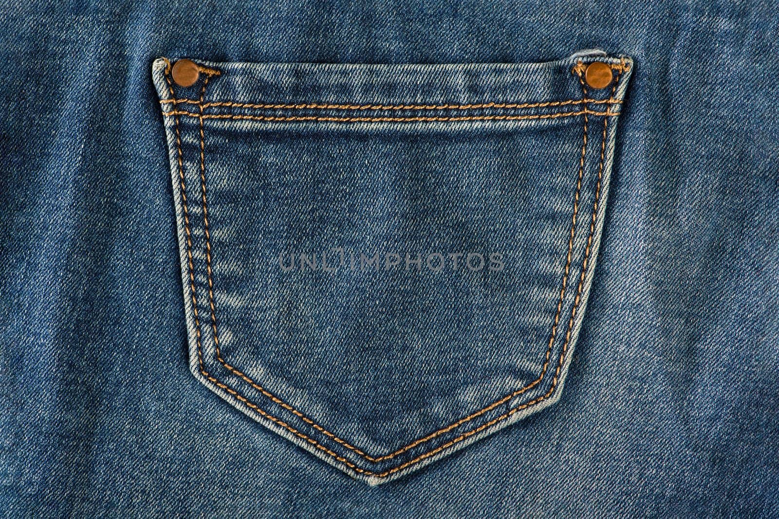 Pocket of old jeans. Empty back pocket of old blue jeans close-up. by SERSOL