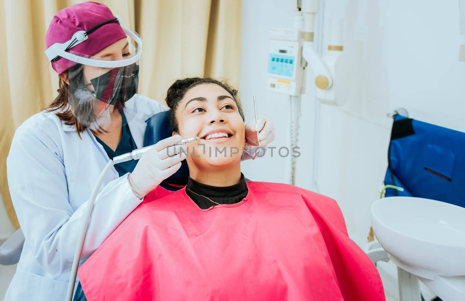 Female dentist cleaning a patient mouth with a drill. Close-up of a stomatologist cleaning a woman teeth, Stomatologist cleaning caries with drill, Stomatologist cleaning a patient teeth