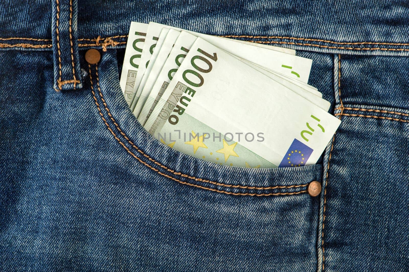 A stack of 100 euro bills in a jeans pocket. Money in the front pocket of jeans. The concept of investment, cash, wealth and profit, copyspace. by SERSOL