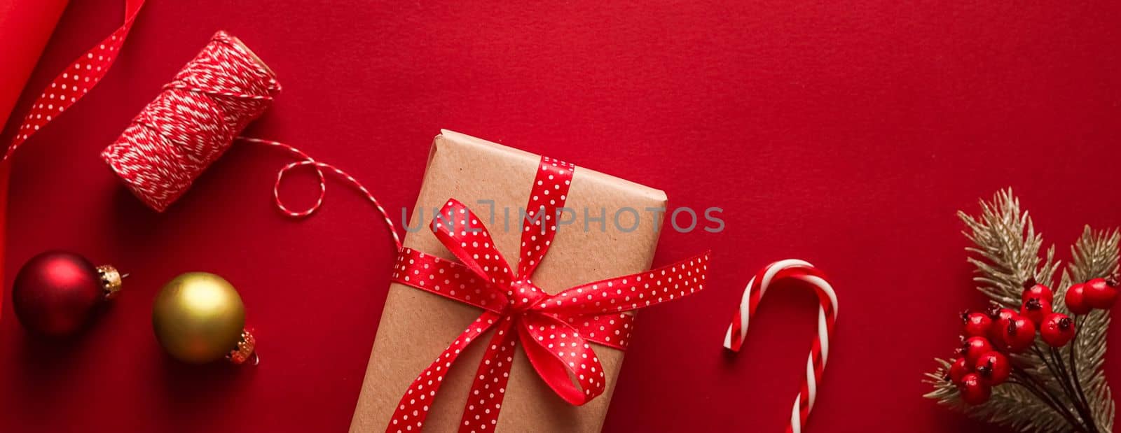 Christmas preparation, boxing day and holidays gift giving, xmas craft paper and ribbons for gifts boxes on red background as wrapping tools and decorations, diy presents as holiday flat lay design