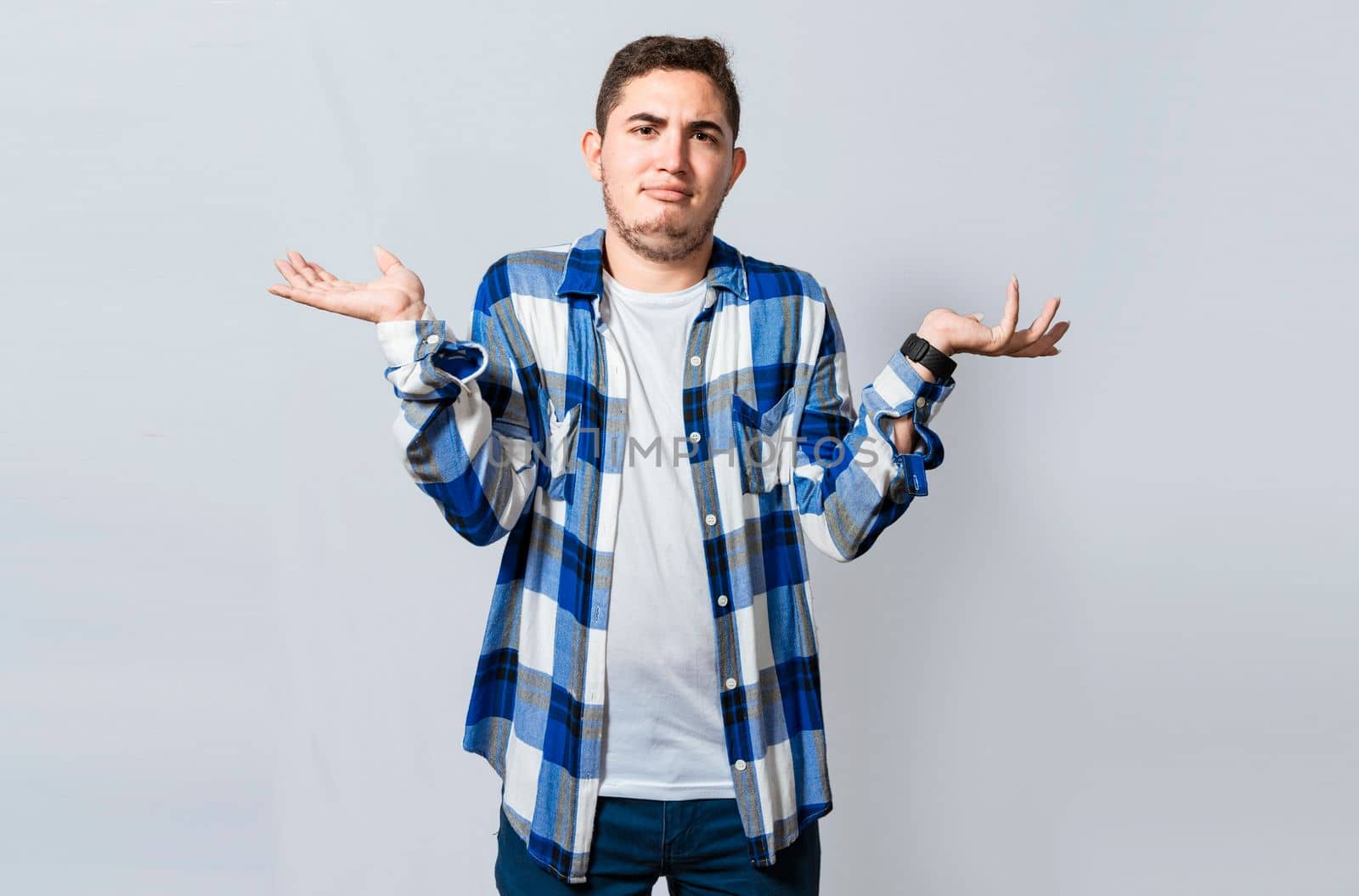 Man spreading palms, feeling clueless and uncertain. Person with puzzled gesture spreading hands, Concept of a puzzled man spreading hands isolated. Guy with puzzled gesture spreading palms by isaiphoto