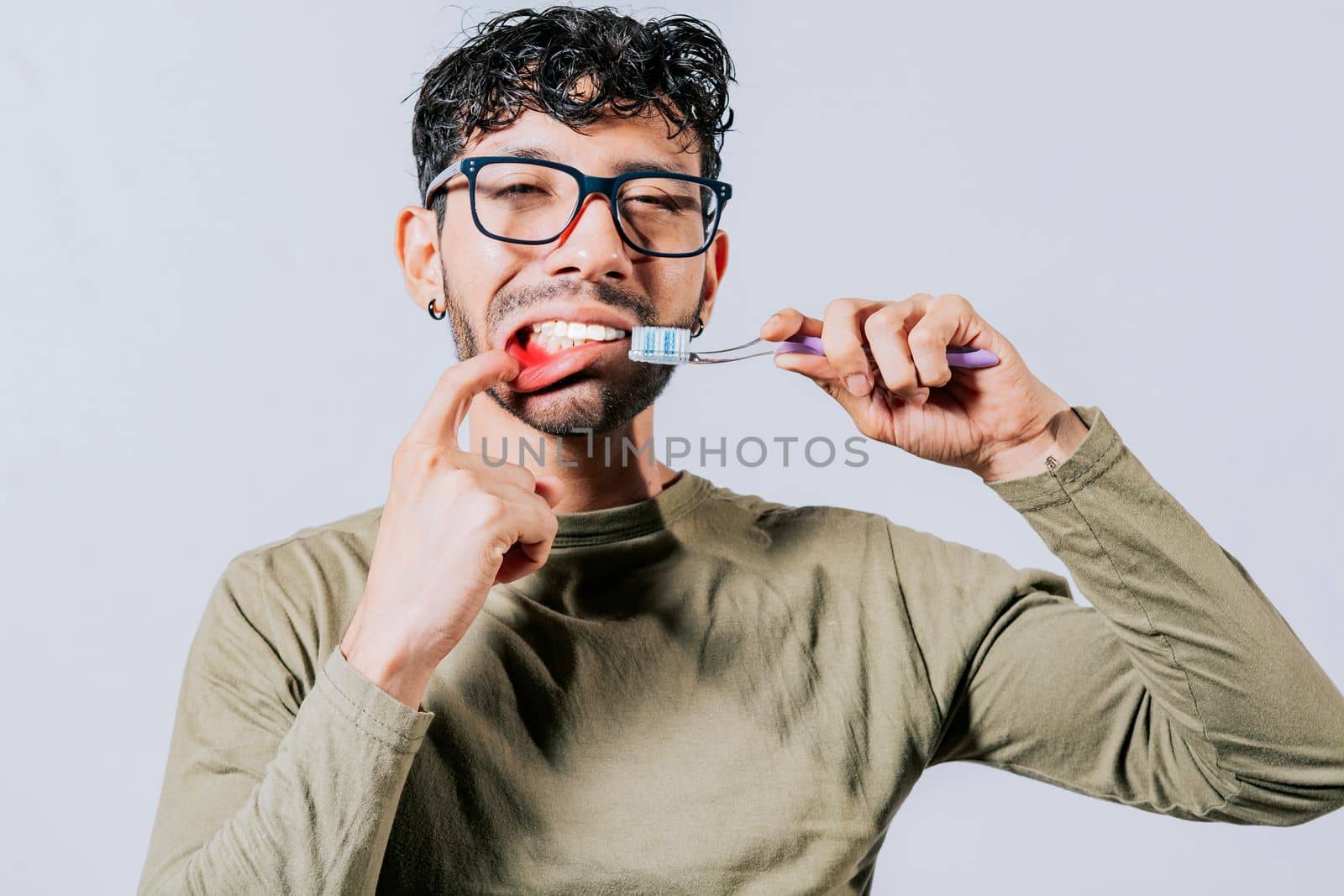 Man holding toothbrush with gum pain, People holding toothbrush with gum problem isolated. Young man with gingivitis holding toothbrush. People holding toothbrush with gum pain