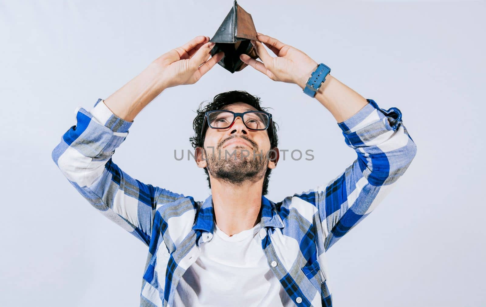 Sad man shaking an empty wallet. Sad person shaking an empty wallet. Man with financial problems shaking wallet. Moneyless frustrated person concept.