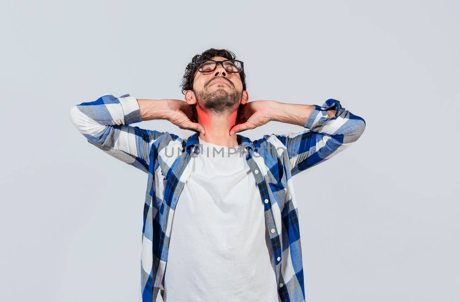 Young man with shoulder and neck problems, Person in pain rubbing his neck isolated, Concept of people with stress and neck pain problems. Tired guy with neck pain isolated