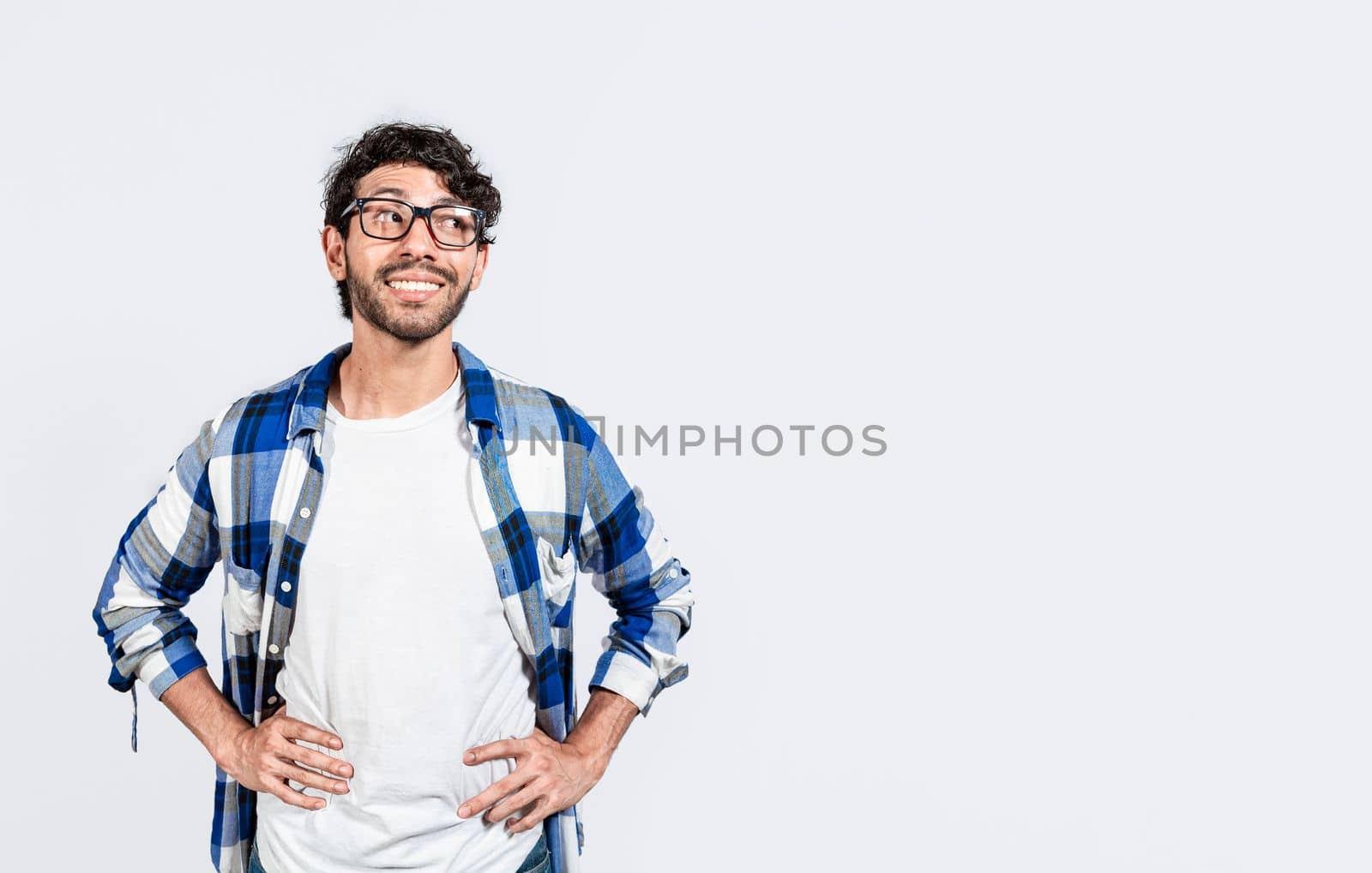 Thoughtful smiling person looking at a blank space. Smiling handsome man looking at an advertisement to the side. smiling man thinking and seeing a blank space