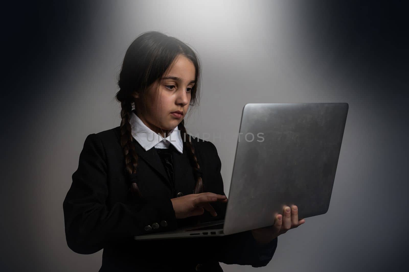 a girl in a black dress, Wednesday girl with a laptop.