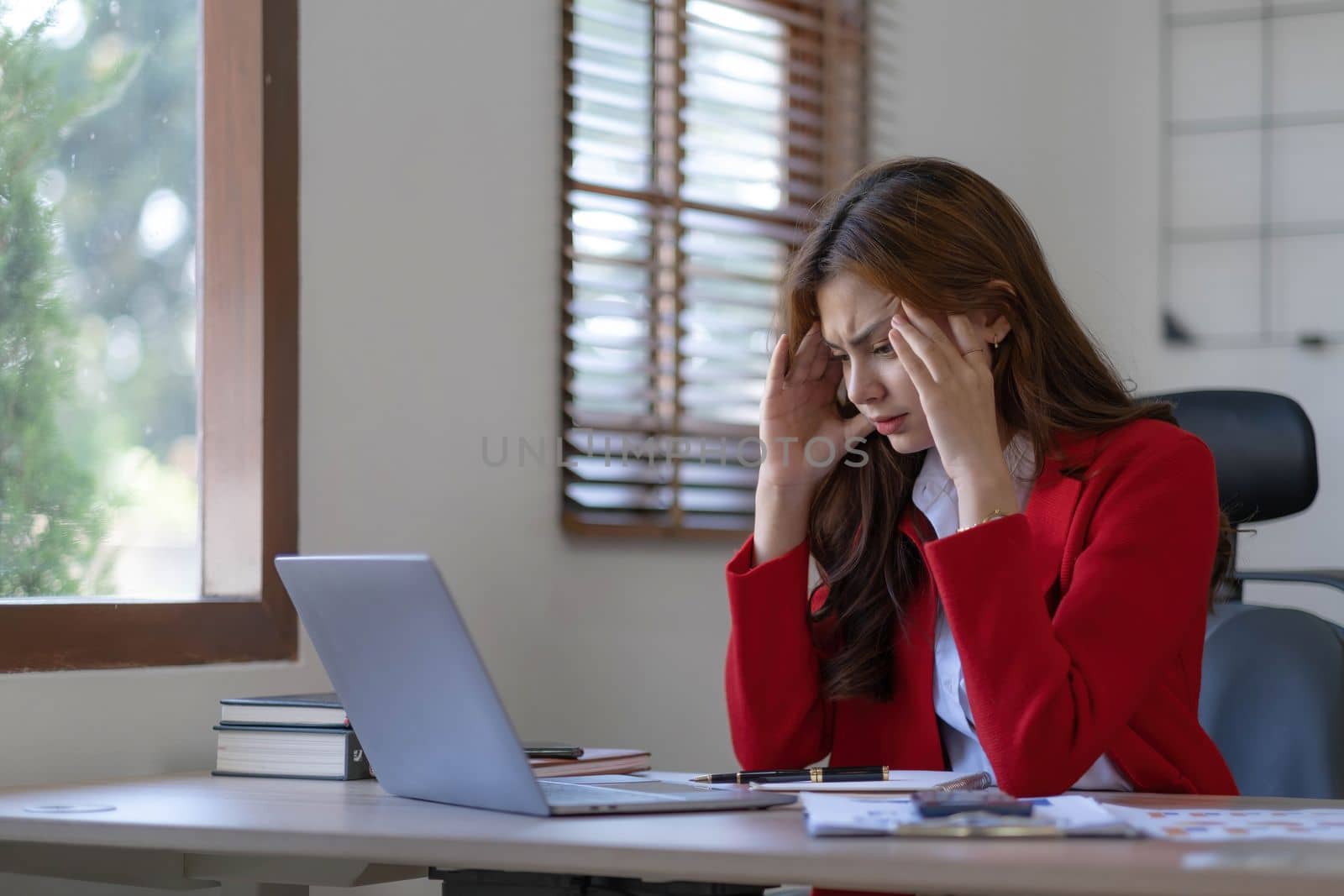 asian woman thinking hard concerned about online problem solution looking at laptop screen, worried serious asian businesswoman focused on solving difficult work computer task..