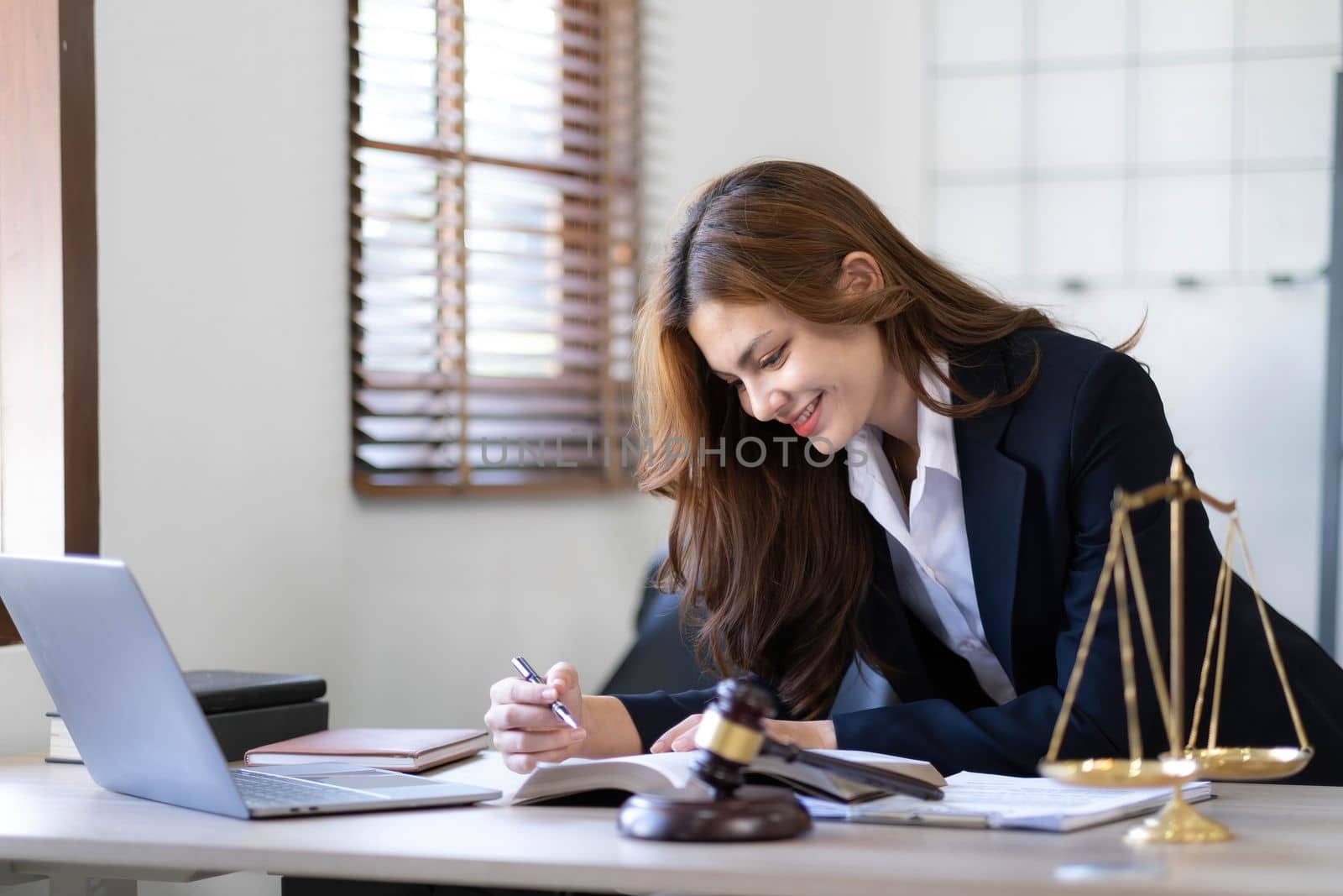 Beautiful asian woman lawyer working and gavel, tablet, laptop in front, Advice justice and law concept