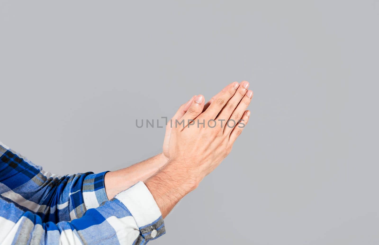 Two hands together in prayer position. Two hands together in prayer on isolated background. Concept of prayer and hands together. Two hands together thanking or asking for forgiveness