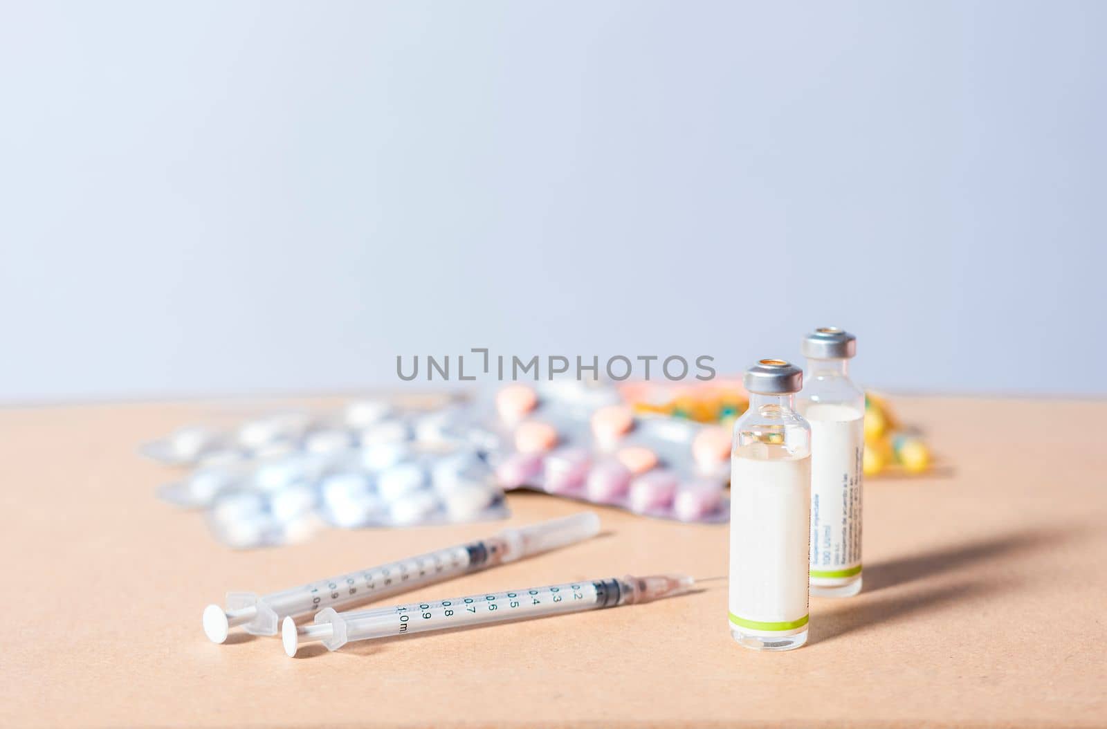 Medicines, pills and syringes on isolated background. Close up of variety of medicines on white background, Concept of addiction to medicines and syringes