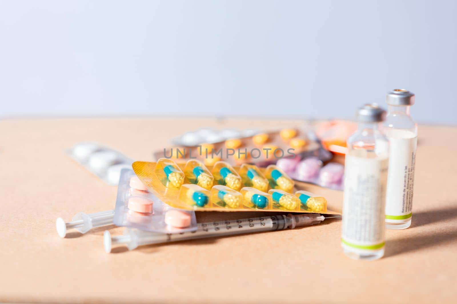 Close up of variety of medicines isolated, Concept of addiction to medicines and syringes. Concept of inappropriate use of medicines. Medicines, pills and syringes on isolated background by isaiphoto
