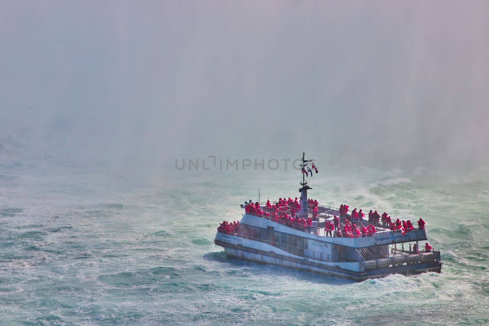 Tourist ship sailing into heavy mist at Niagara Falls by njproductions