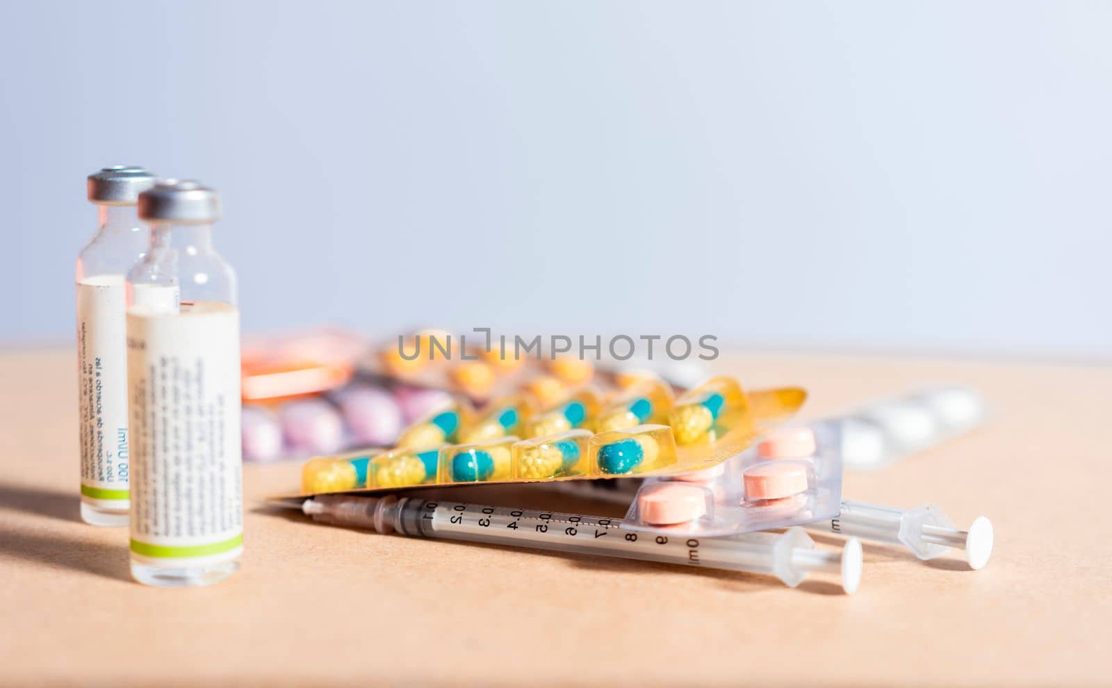 Concept of addiction to medicines and syringes. Concept of inappropriate use of medicines. Medicines, pills and syringes on isolated background, Close up of variety of medicines isolated by isaiphoto