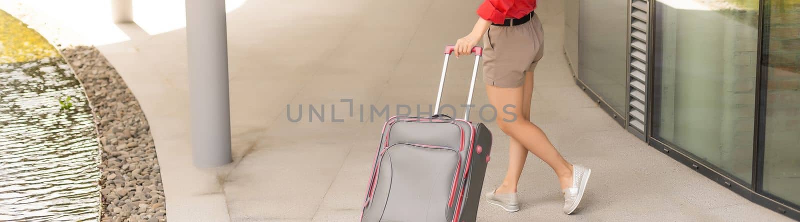 travel background, woman tourist walking with suitcase on the street in european city, tourism in Europe.