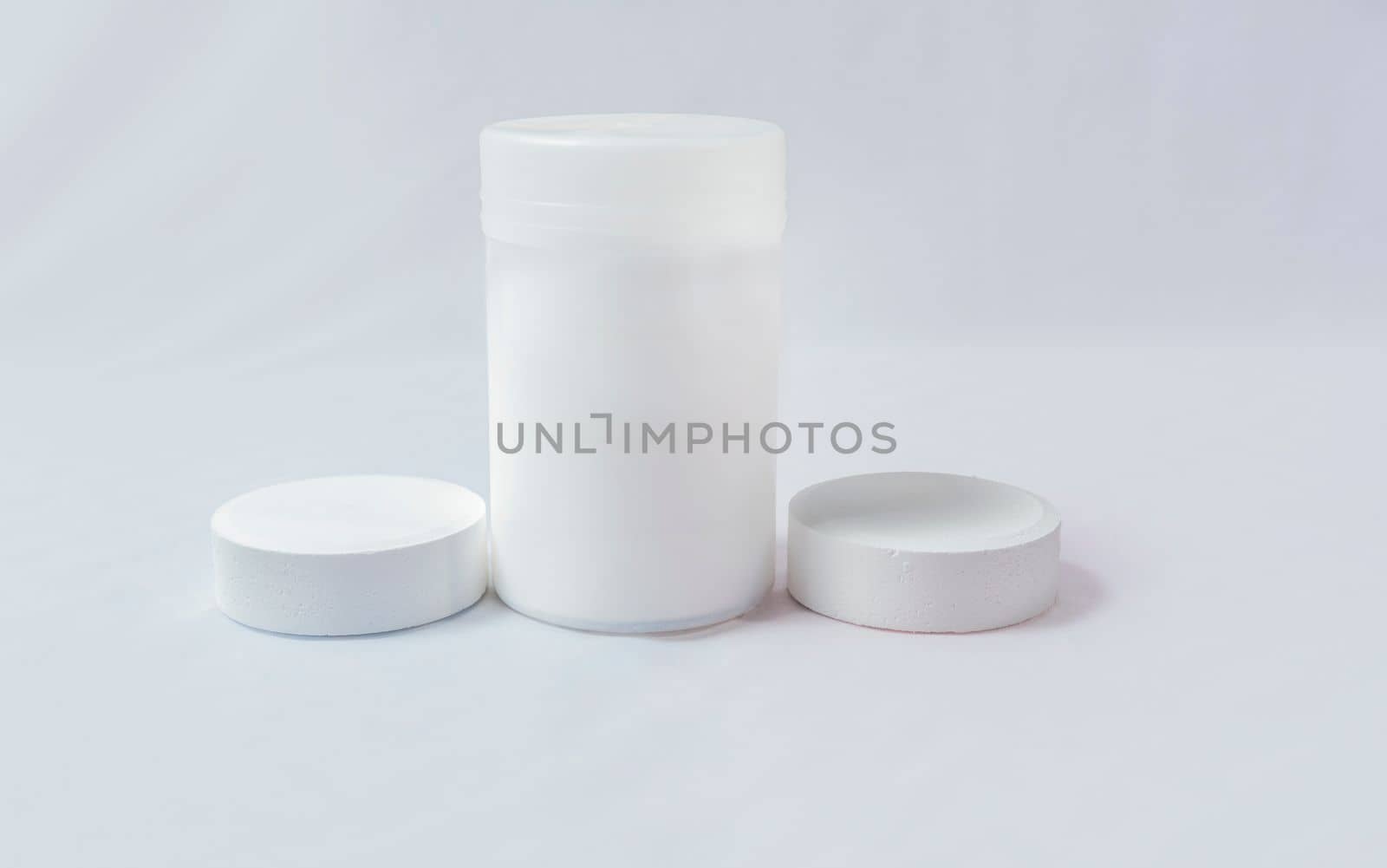 Swimming pool cleaning and maintenance chlorine tablets. Chlorine tablets for pool cleaning on isolated background. Chlorine tablets for swimming pool disinfection on white background