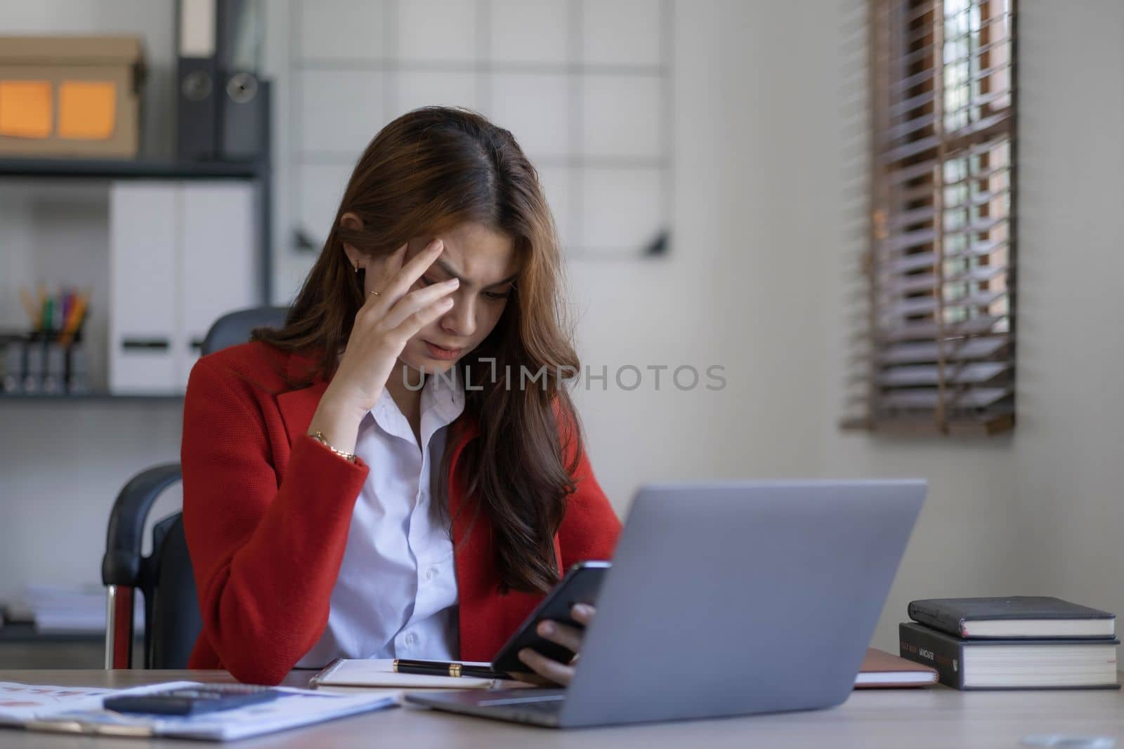 asian woman thinking hard concerned about online problem solution looking at laptop screen, worried serious asian businesswoman focused on solving difficult work computer task..