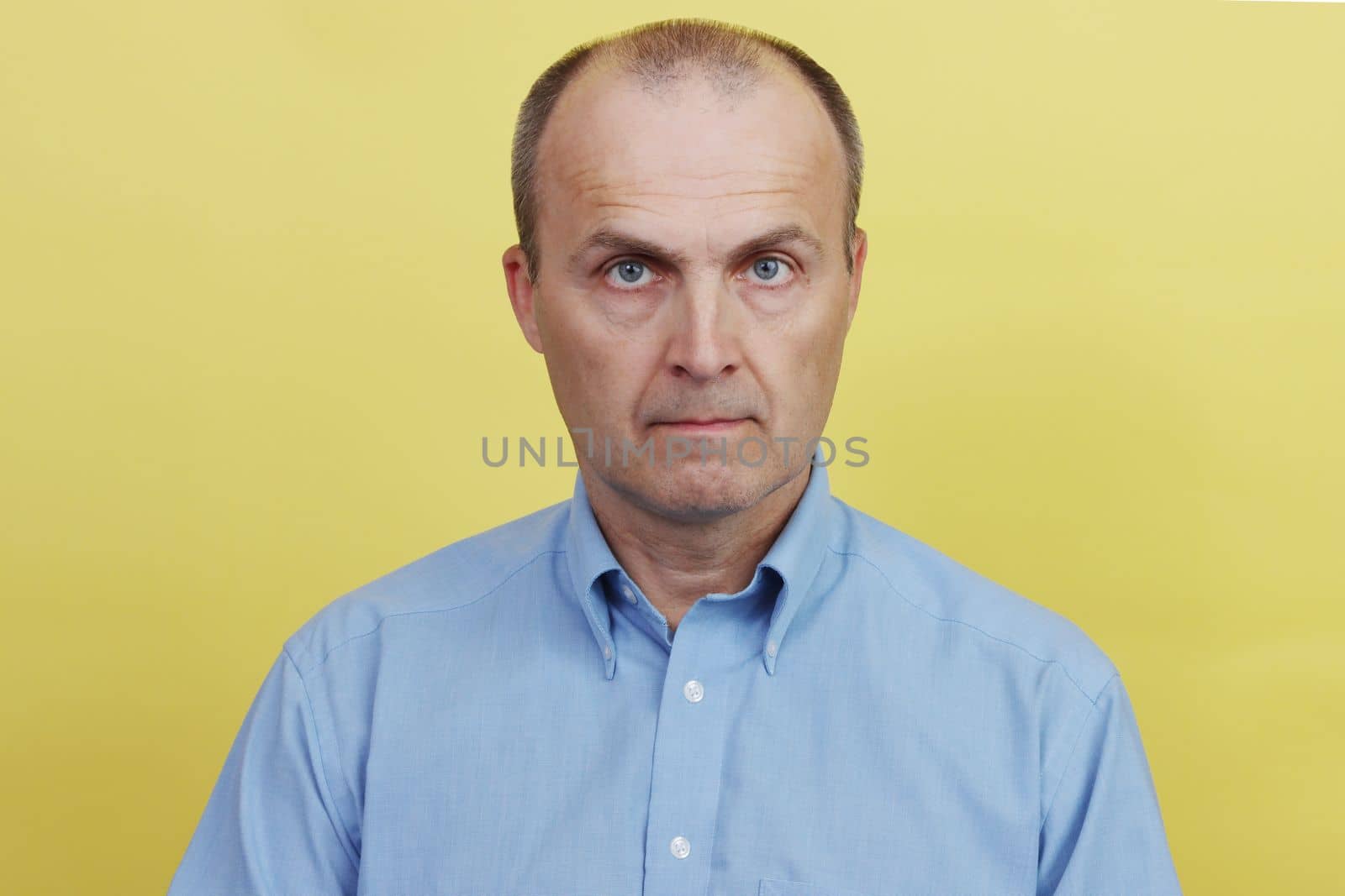 Full face portrait of a handsome elderly man in a blue shirt. by gelog67