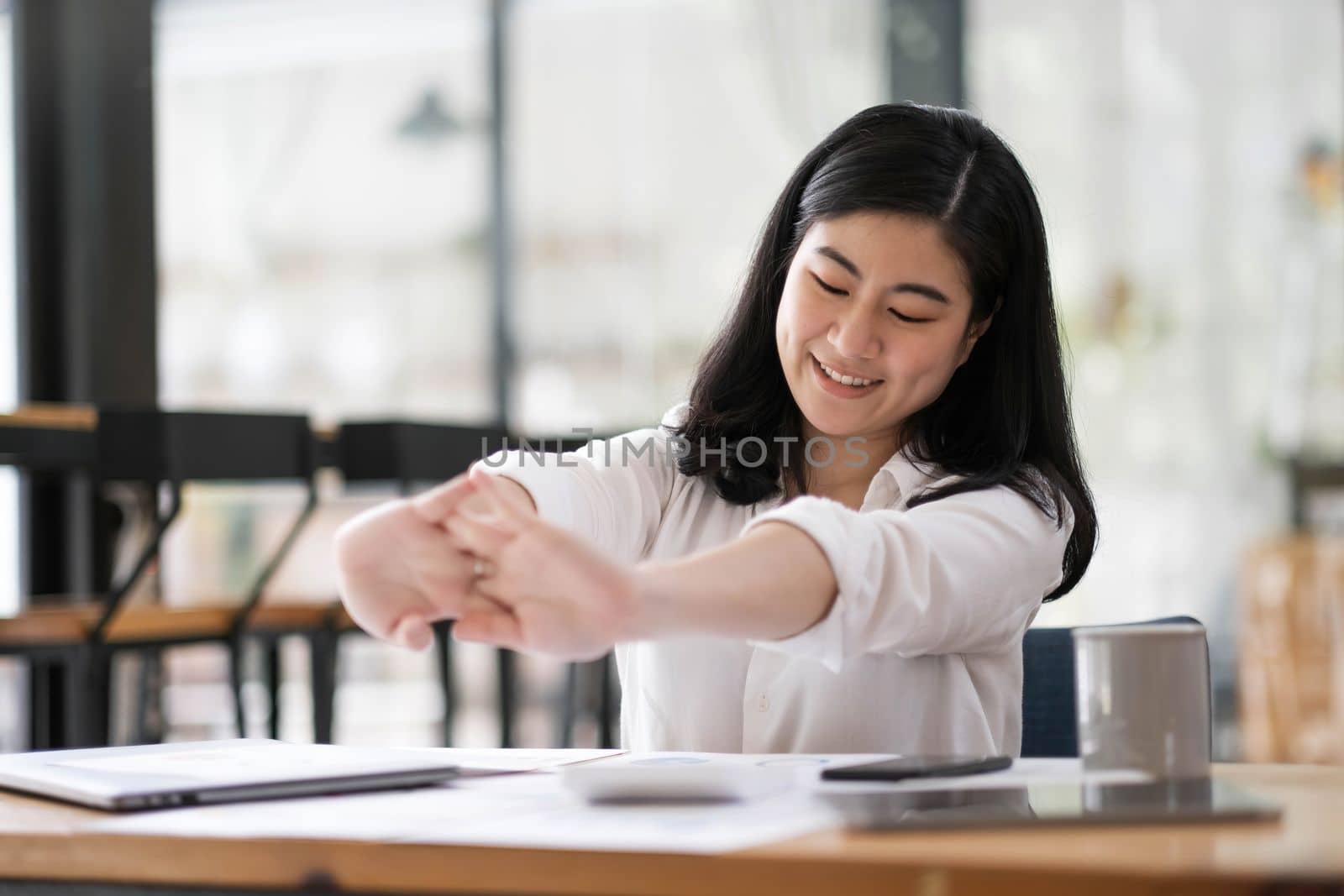 business woman work from home and stretching her body because feel tired after working on tablet computer, Lifestyle woman relax after working at home concept...