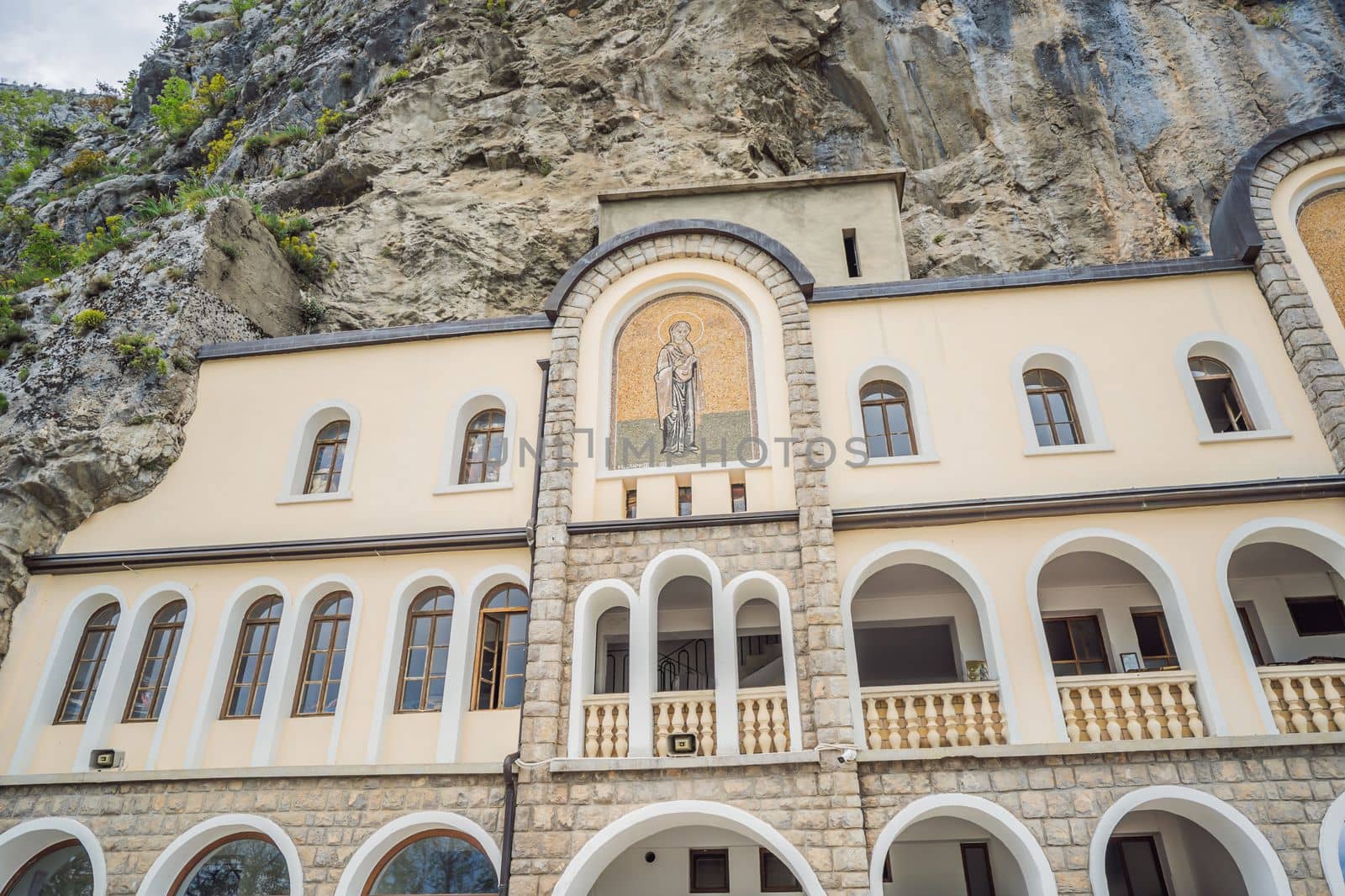 Monastery of Ostrog, Serbian Orthodox Church situated against a vertical background, high up in the large rock of Ostroska Greda, Montenegro. Dedicated to Saint Basil of Ostrog by galitskaya