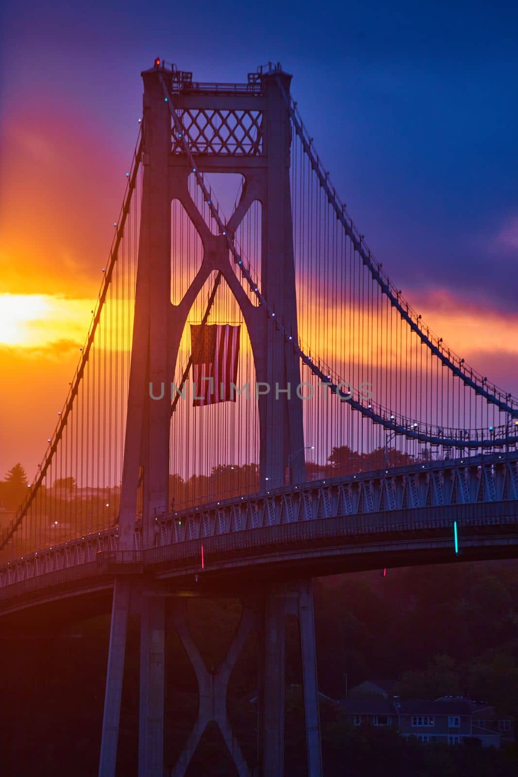 Stunning golden sunrise over American Bridge highlighting American Flag hanging by njproductions