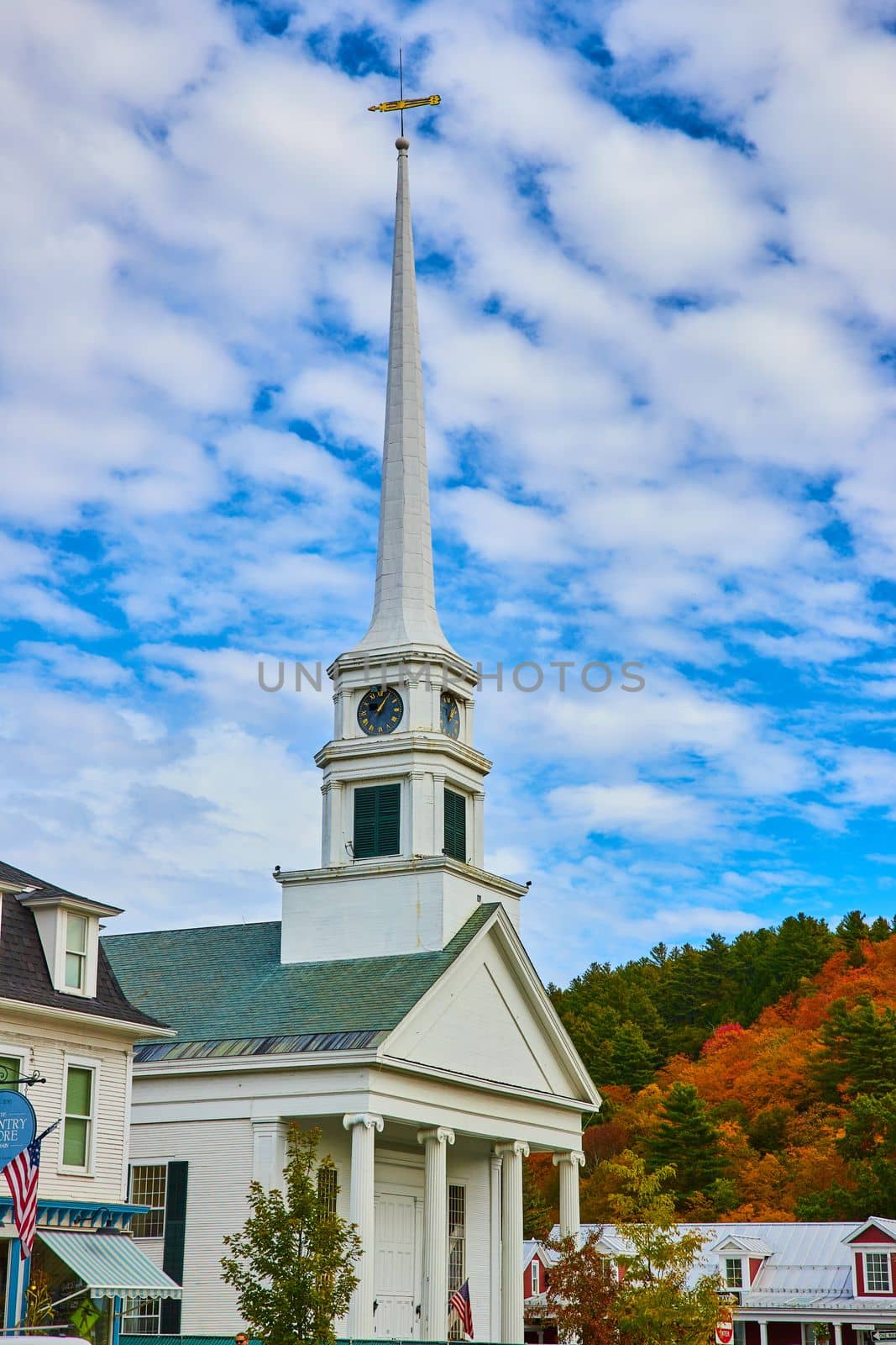 Small town white steeple Christian Church during fall by njproductions