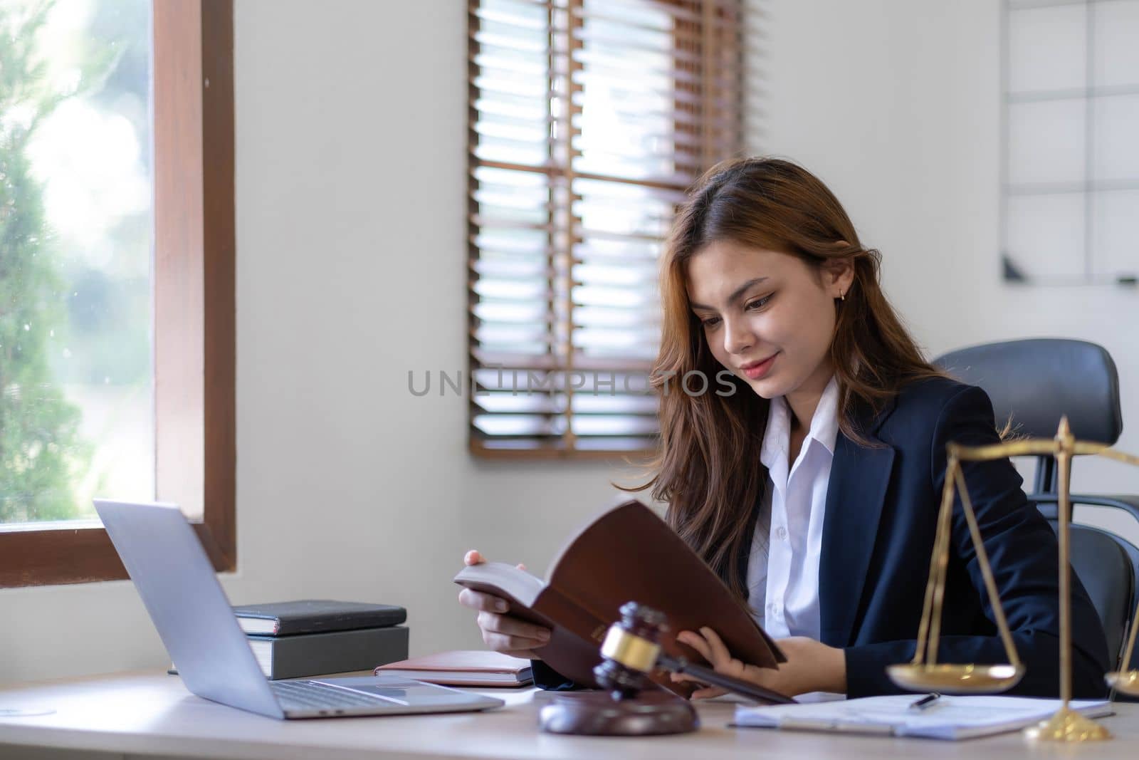 Beautiful asian woman lawyer working and gavel, tablet, laptop in front, Advice justice and law concept