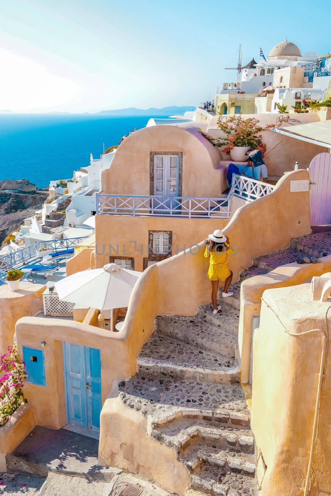 Santorini Greece, woman on luxury vacation Oia Santorini Island Greece visit the white village with beautiful building overlooking the caldera ocean