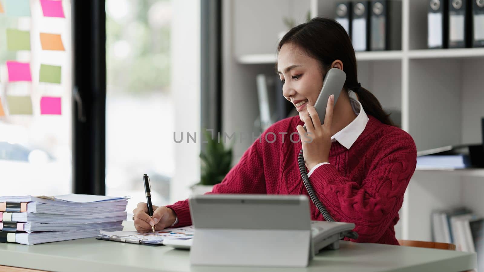 Pleasant positive business woman using digital tablet at home office.