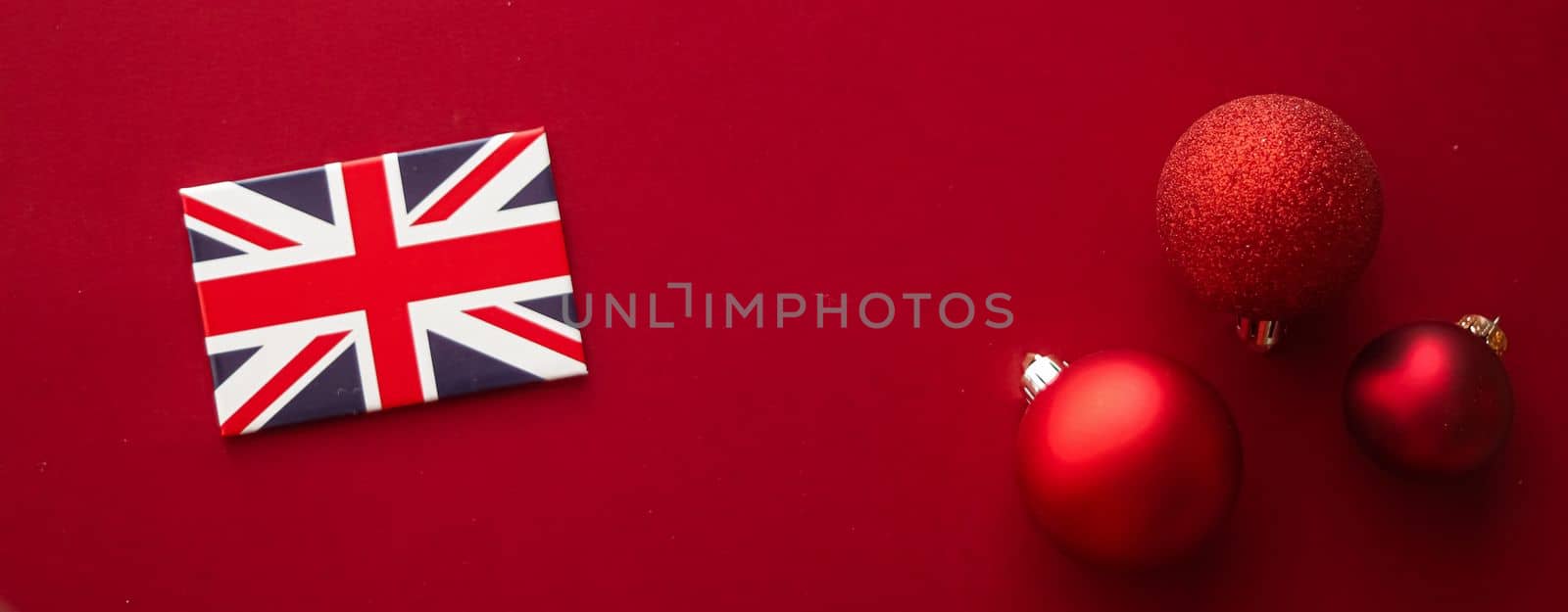 Christmas holiday tradition in United Kingdom and happy holidays flat lay, british flag, xmas ornaments and decoration on festive red background as flatlay design, top view